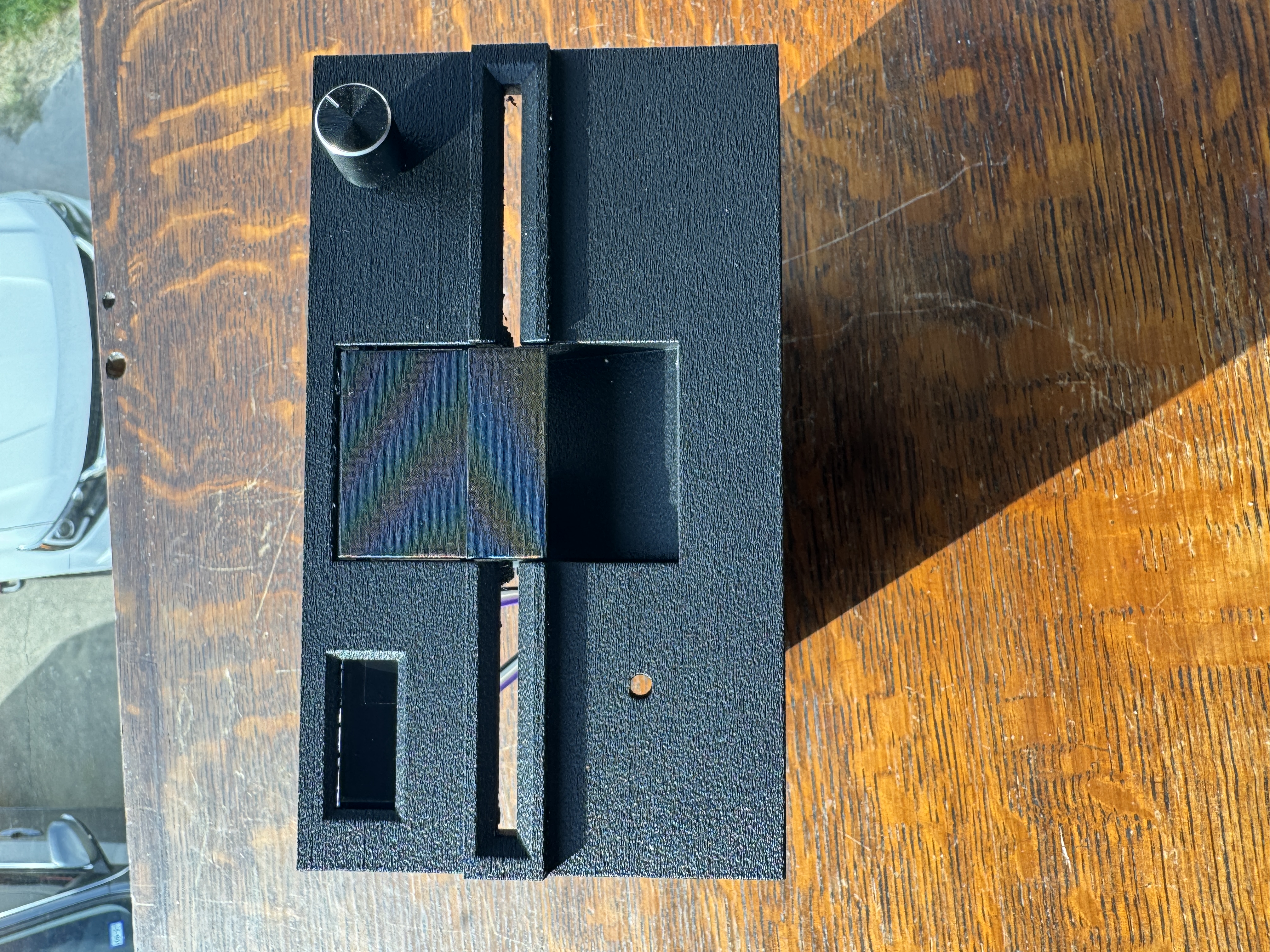 Front view of custom drive bezel with lever and opening for media access