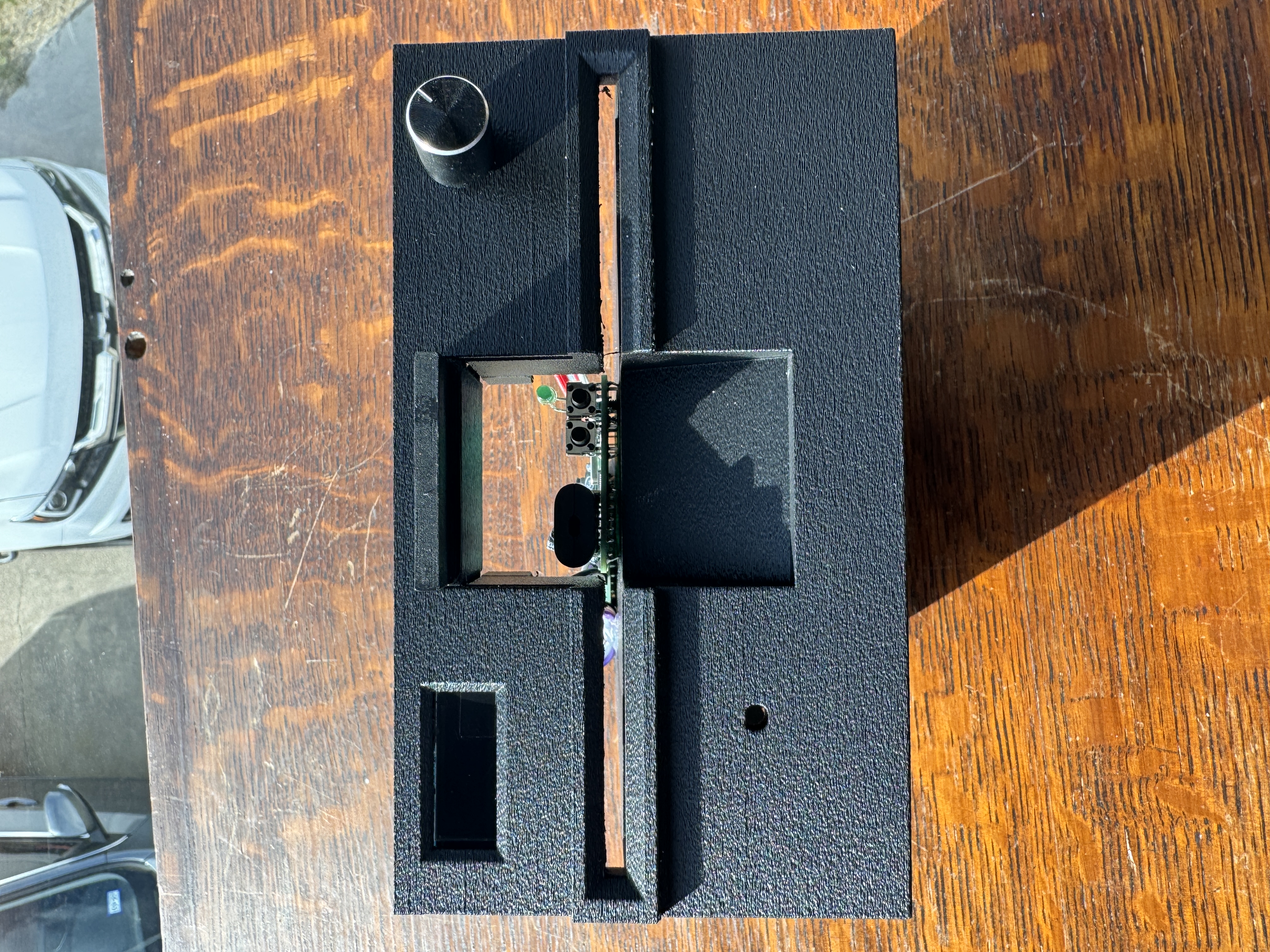 Close-up of the custom bezel showing media access opening