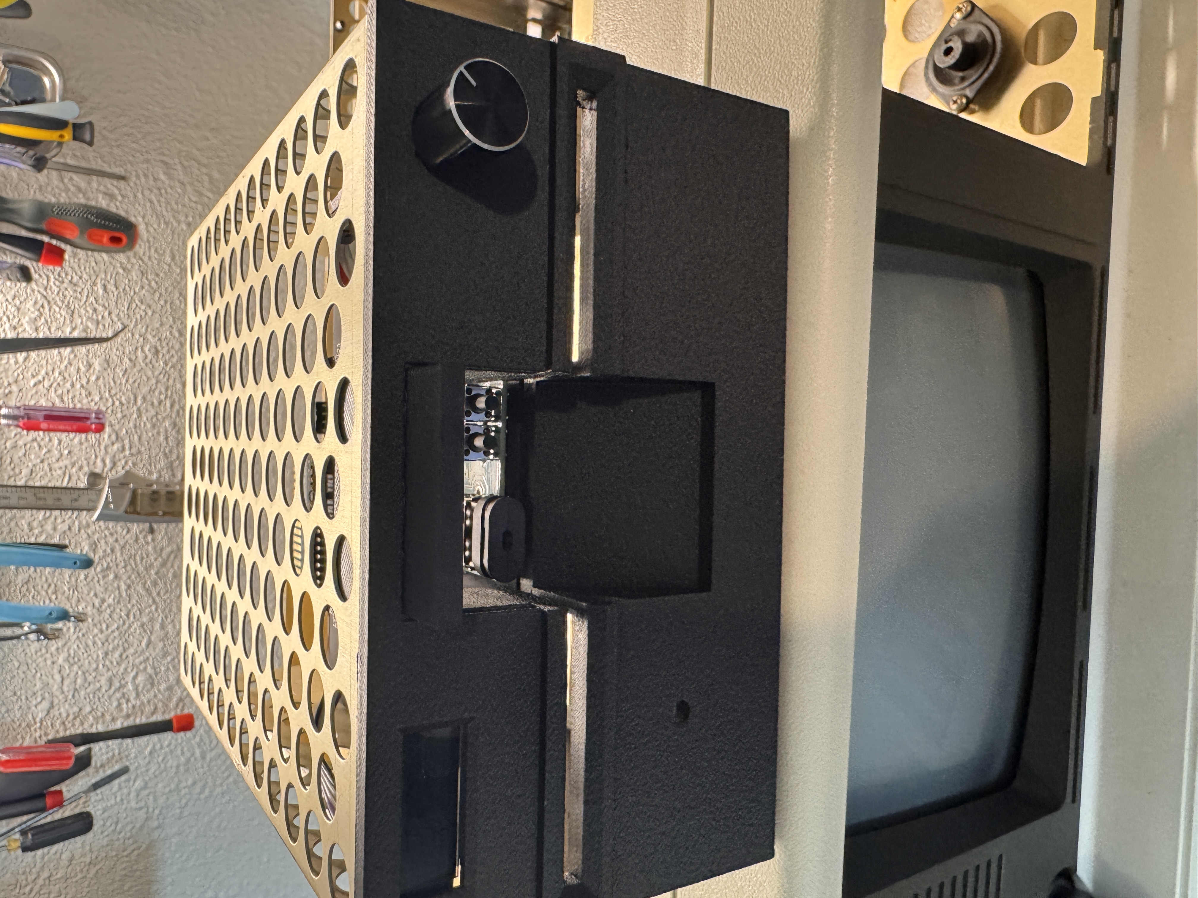 Custom replacement bezel mounted in the front drive bay opening